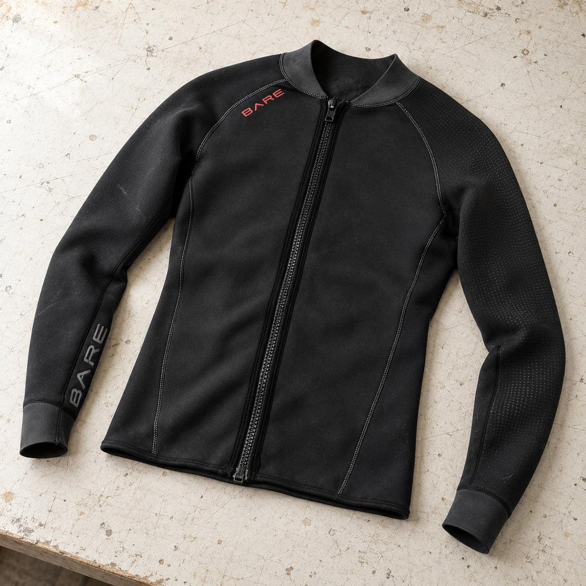 Open Box Bare EXOWEAR Jacket Mens — Black, open box, lightly used on off-white work table