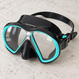 Open Box Atomic Aquatics SubFrame Mask — Black/Aqua, open box, lightly used on off-white work table