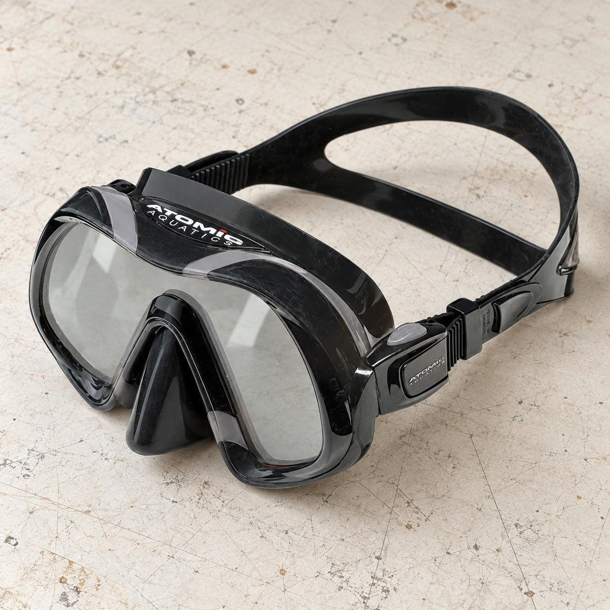 Open Box Atomic Aquatics Venom Mask — Black/Gray, open box, lightly used on off-white work table
