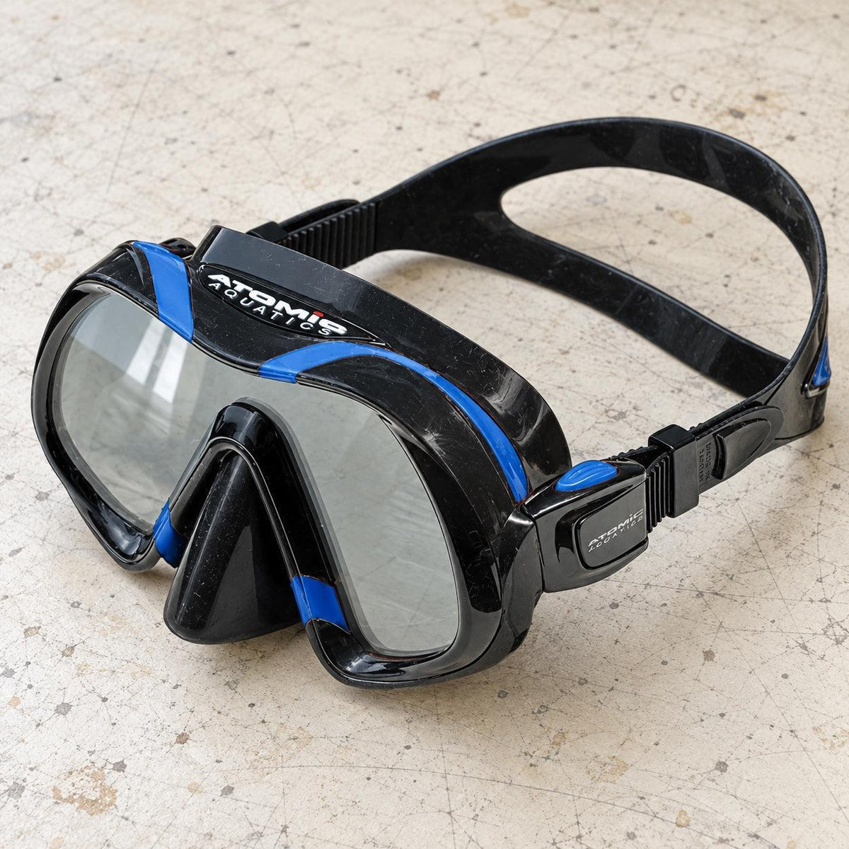 Open Box Atomic Aquatics Venom Mask — Black/Blue, open box, lightly used on off-white work table