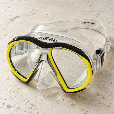 Open Box Atomic Aquatics SubFrame Mask, Medium Fit — Clear/Yellow, open box, lightly used on off-white work table