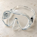 Open Box Atomic Aquatics Frameless Mask — Clear, open box, lightly used on off-white work table