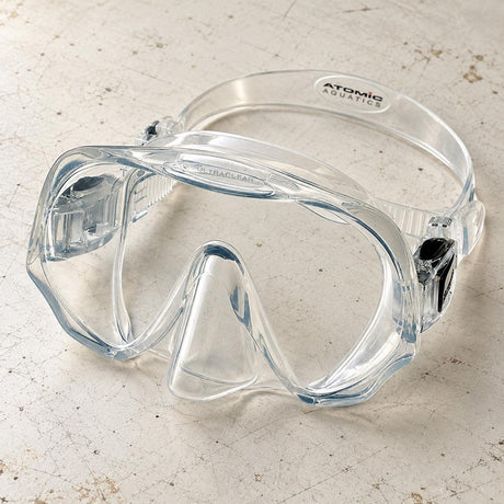 Open Box Atomic Aquatics Frameless Mask — Clear, open box, lightly used on off-white work table