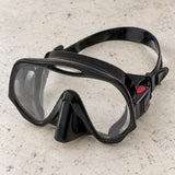 Open Box Atomic Aquatics Frameless Mask — Black, open box, lightly used on off-white work table
