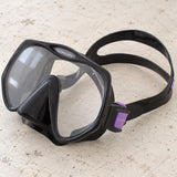 Open Box Atomic Aquatics Frameless Mask — Black/Purple, open box, lightly used on off-white work table