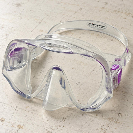 Open Box Atomic Aquatics Frameless Mask — Clear/Purple, open box, lightly used on off-white work table