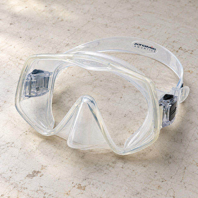 Open Box Atomic Aquatics Frameless 2 Mask — Clear, open box, lightly used on off-white work table