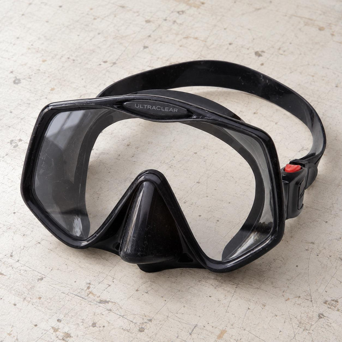 Open Box Atomic Aquatics Frameless 2 Mask — Black, open box, lightly used on off-white work table