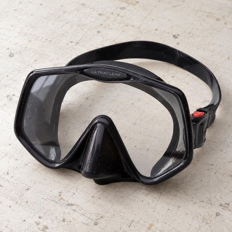 Open Box Atomic Aquatics Frameless 2 Mask — Black, open box, lightly used on off-white work table