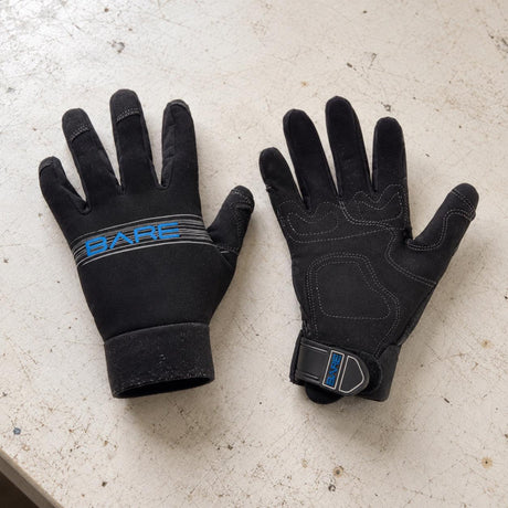 Open Box Bare 2mm Tropic Pro Dive Gloves — Black, open box, lightly used on off-white work table