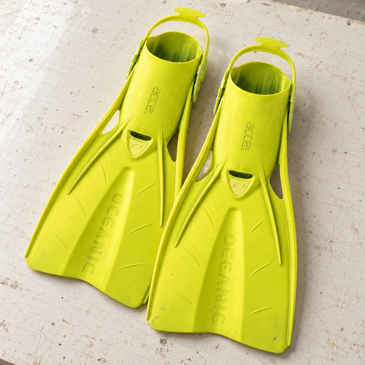 Open Box Oceanic Accel Fin — Yellow, open box, lightly used on off-white work table