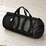 Open Box Stahlsac 26 Mesh Duffle — Black, open box, lightly used on off-white work table