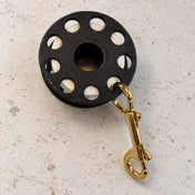 Open Box Zeagle Lightweight Thumb Reel — default, open box, lightly used on off-white work table